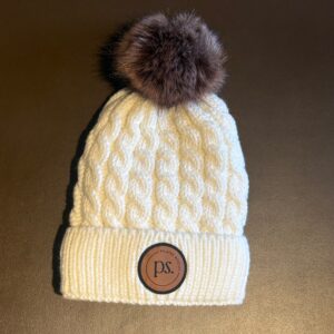 Removable Pom, leather patch with logo.